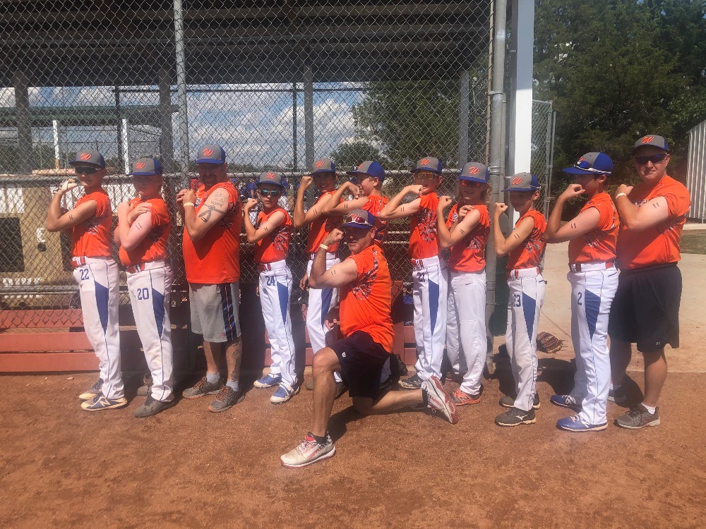 Wyatt's baseball team supporting Wyatt, who was in the hospital, by writing his number on their arms