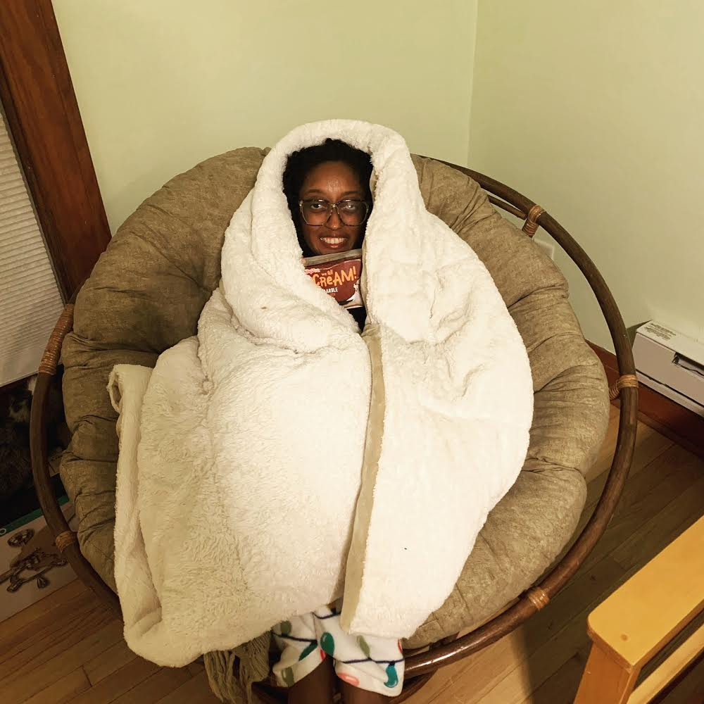 After a long day of dissertation writing, Raele relaxes in her papason chair.