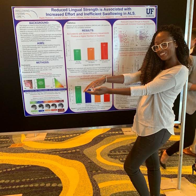 At the 2019 Northeast ALS Consortium Meeting in Clearwater, Florida, Raele does a "gator chomp" in front of her research presentation. This was her last time presenting at the conference as a University of Florida gator.
