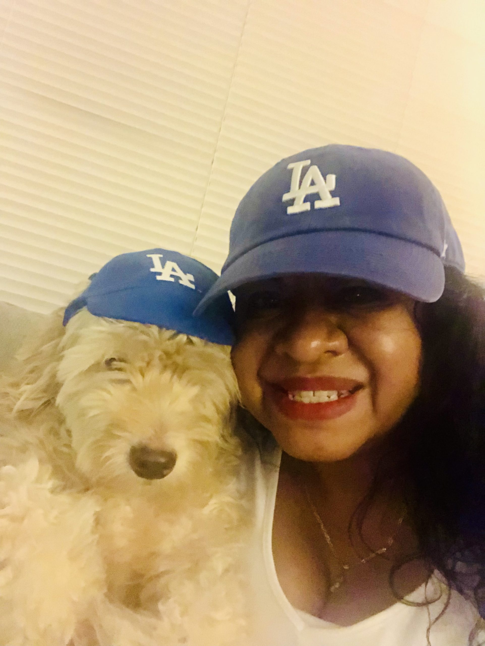 Marissa with her dog, Pancho, wearing Dodgers fan merch