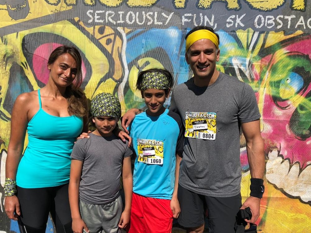 Natasha's family at a mud run obstacle course